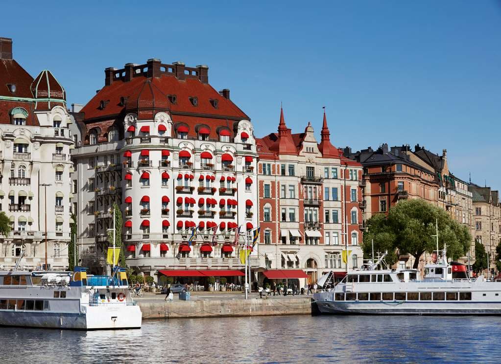 Hotel Diplomat Stockholm Art Nouveau facade with red awnings overlooking the Strandvägen waterfront.