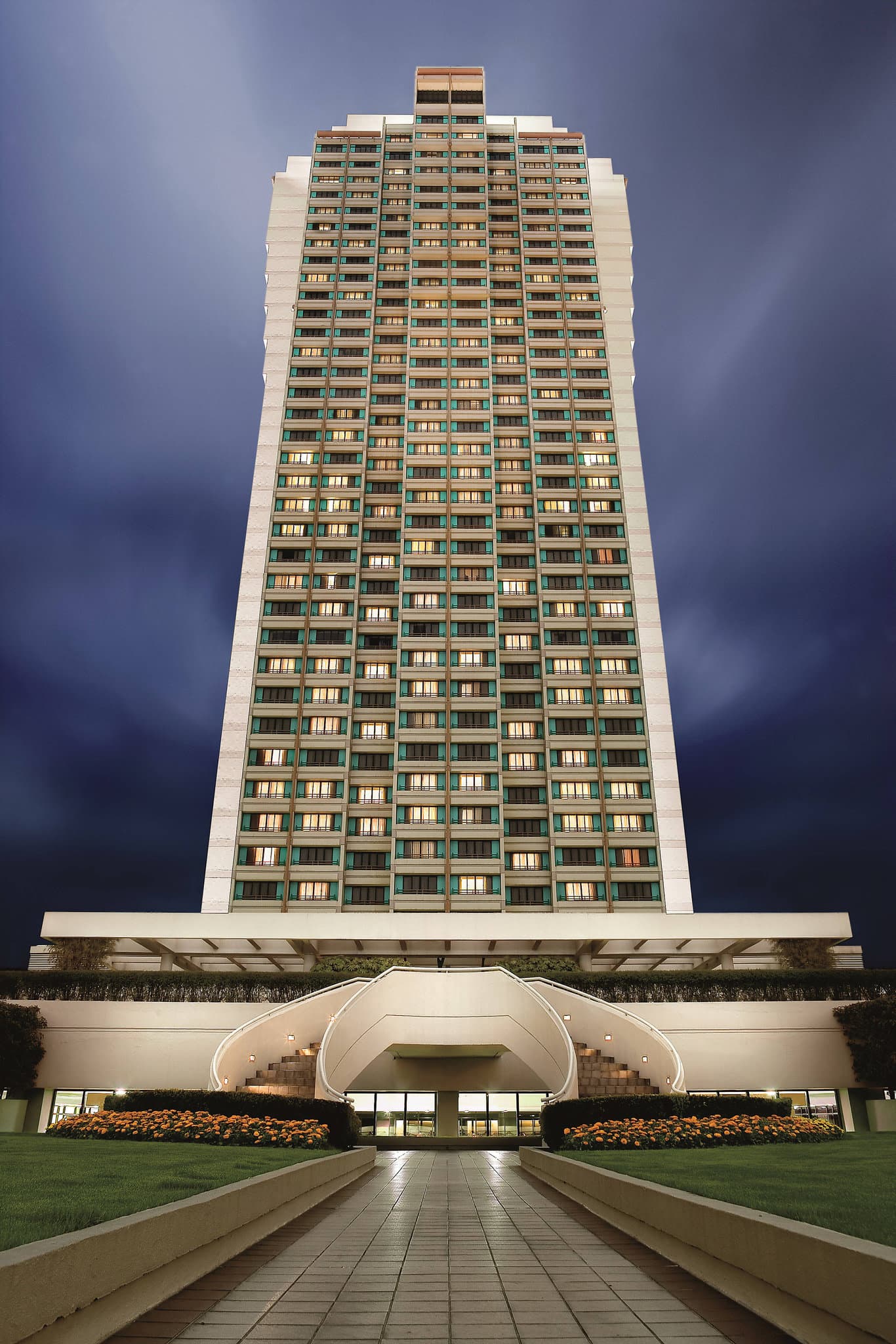 The Portman Ritz-Carlton Shanghai lobby atrium featuring massive wooden columns and a contemporary LED mesh lighting installation.