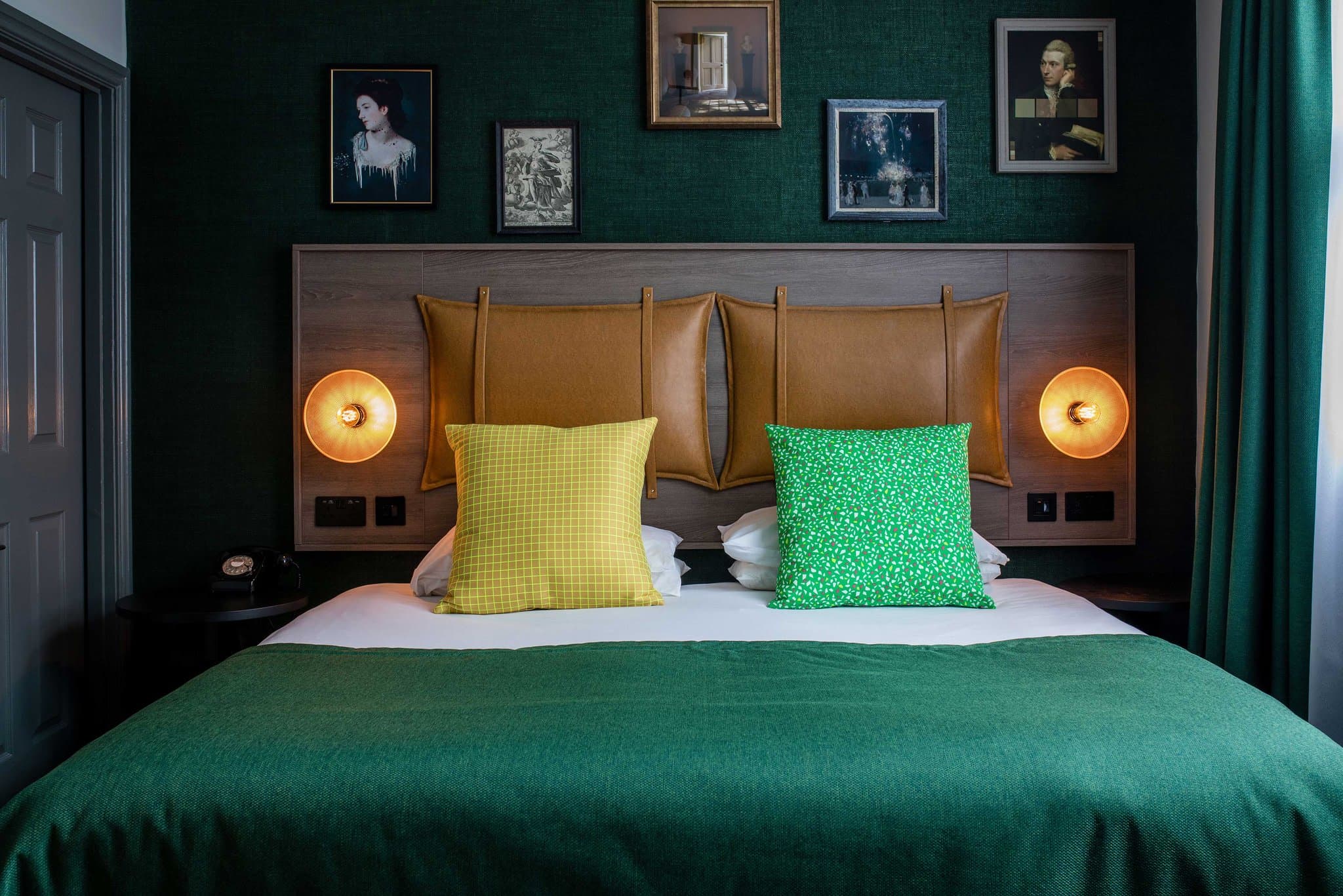 The ArtBar at Abbey Hotel Bath featuring a ceiling of suspended glass decanters and eclectic gallery walls.