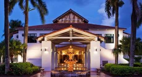 A dramatic architectural archway at Wyndham Grand Rio Mar framing a view of the turquoise Atlantic Ocean and manicured grounds.