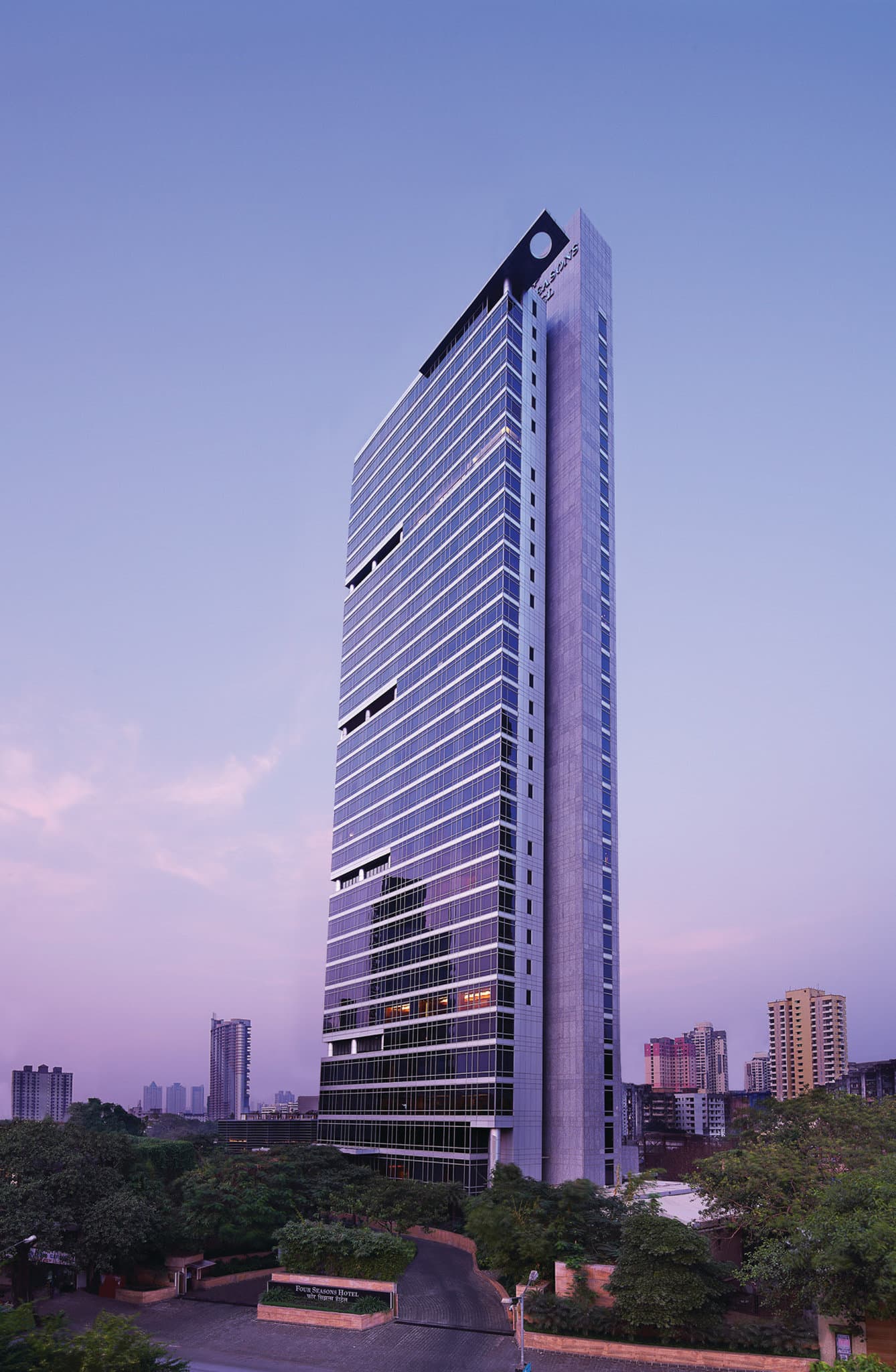 A renovated suite at Four Seasons Mumbai featuring a peacock-themed walk-in closet and a view of the Mahalaxmi Racecourse.