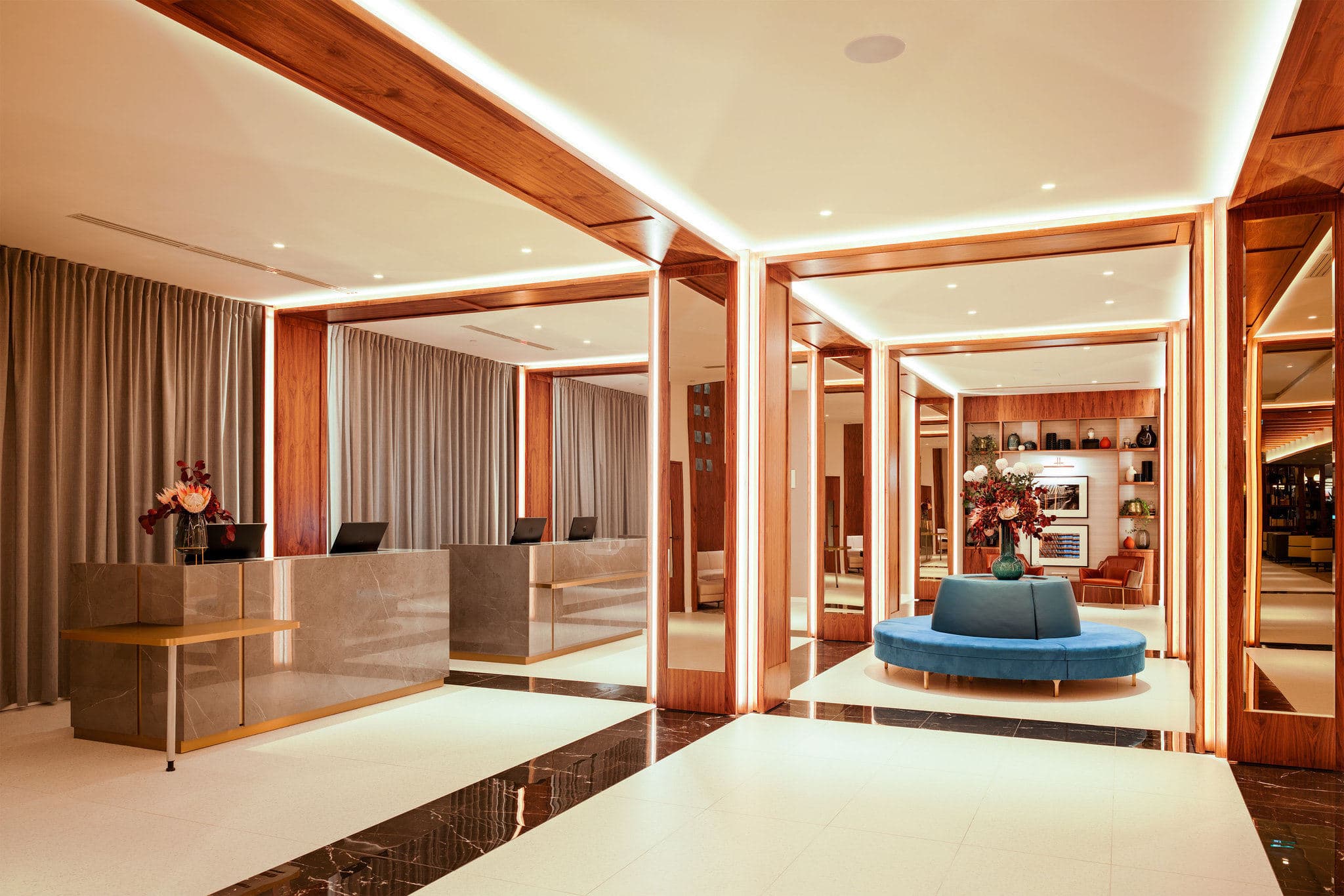 The Sheraton Grand Warsaw lobby featuring the dramatic 'Rotunda' ceramic art wall and modern lounge seating.