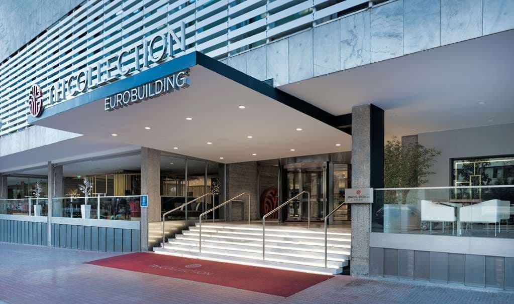 The whimsical entrance of DiverXO restaurant at NH Collection Eurobuilding featuring winged pig sculptures.