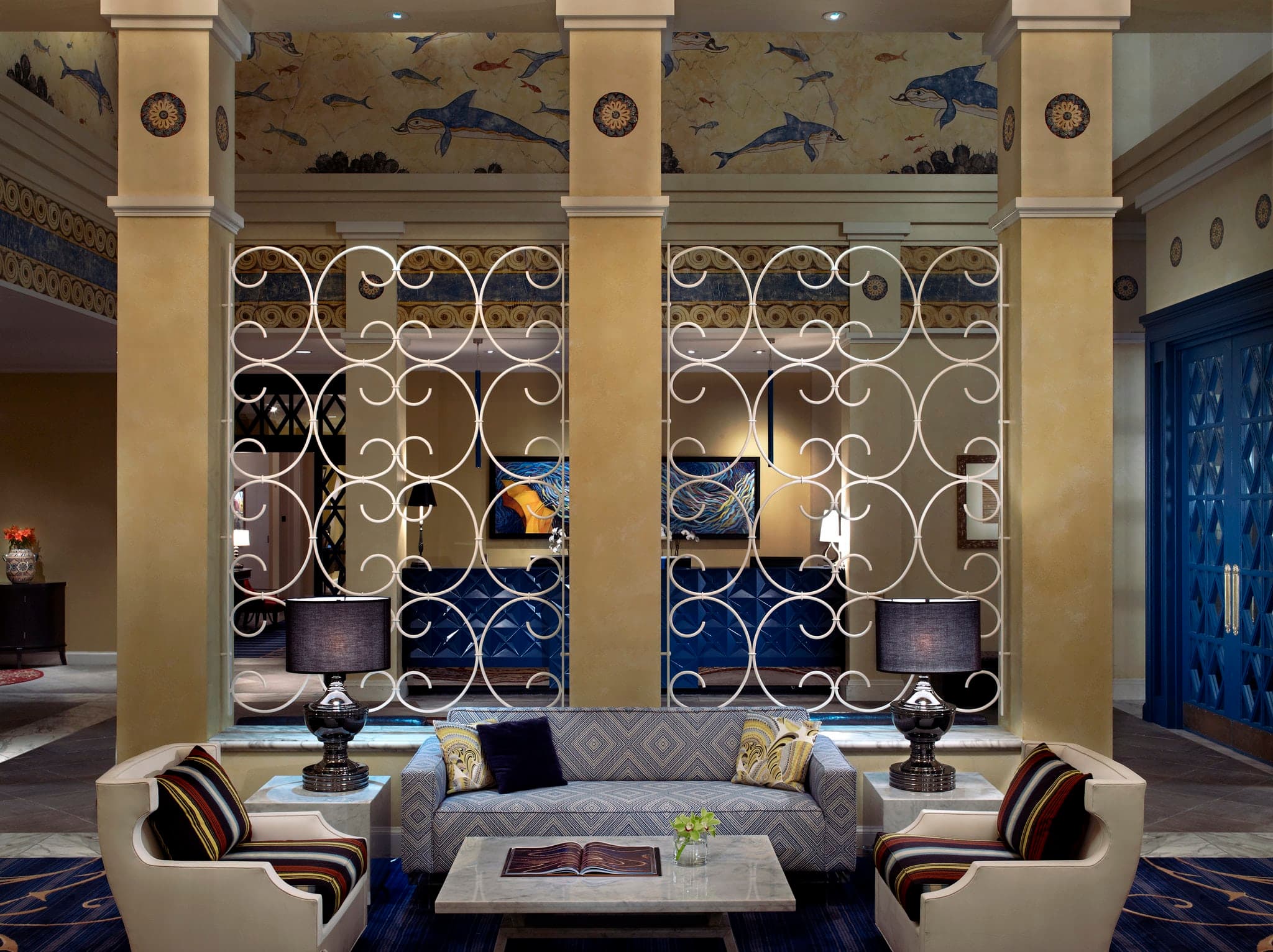 The newly renovated lobby of Kimpton Hotel Monaco Seattle featuring a chic library aesthetic and modern art installations.