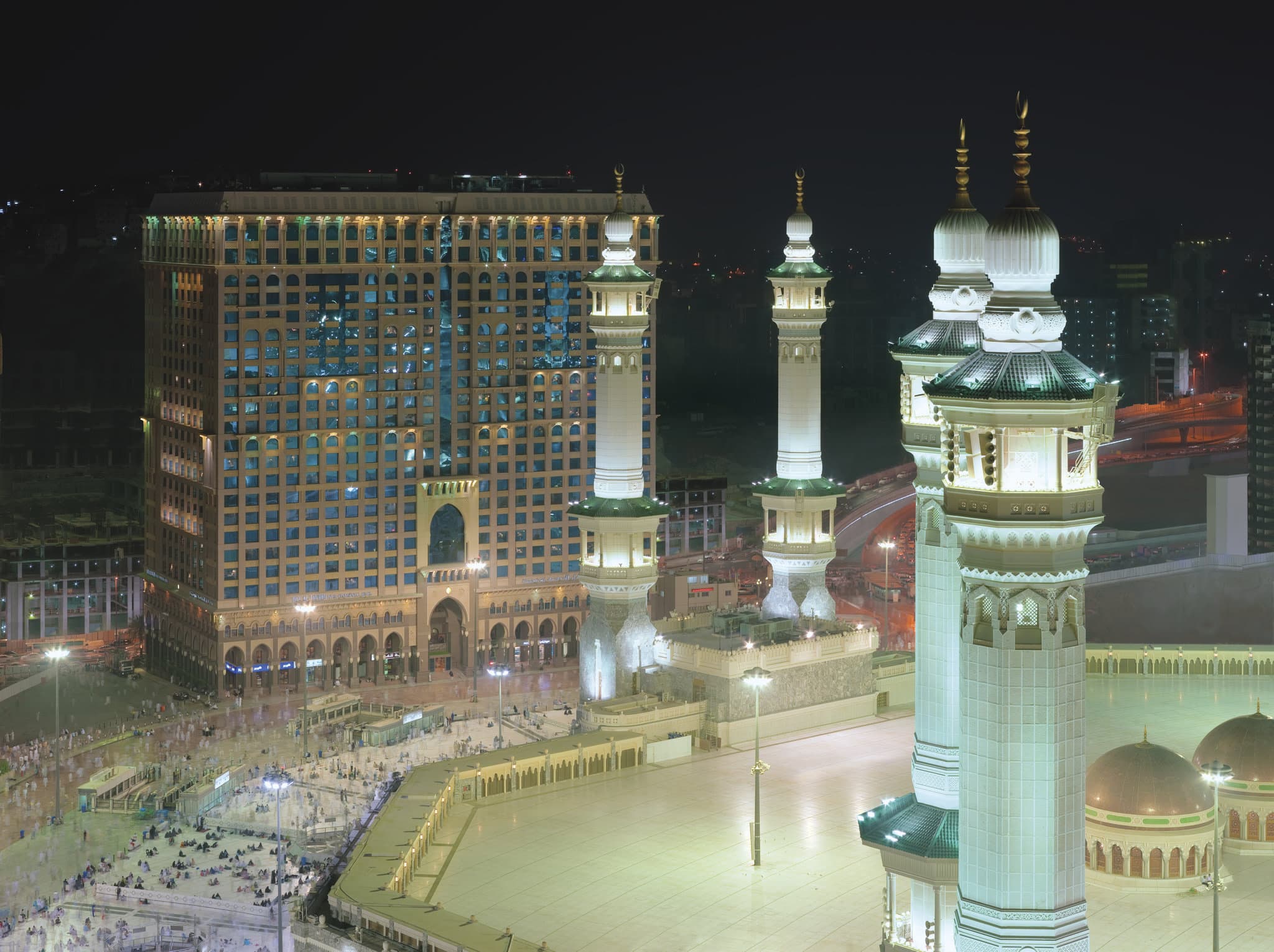 A sweeping view of the Holy Kaaba seen through the arched window of a suite at InterContinental Dar Al Tawhid Makkah.