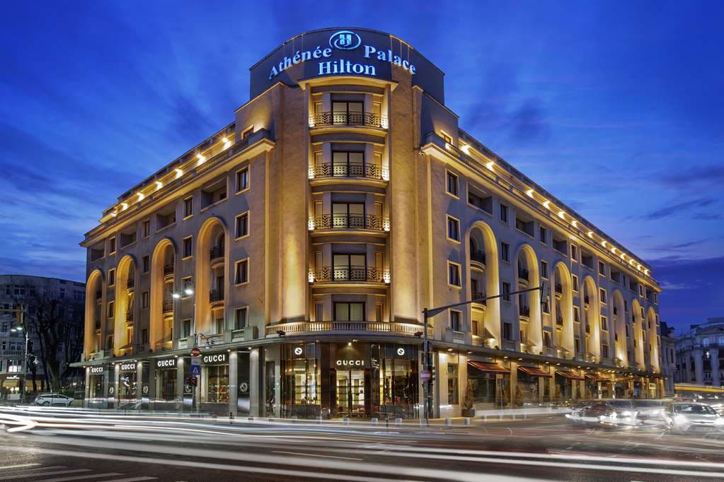 The marble colonnade of the InterContinental Athénée Palace Bucharest lobby, lit by crystal chandeliers.