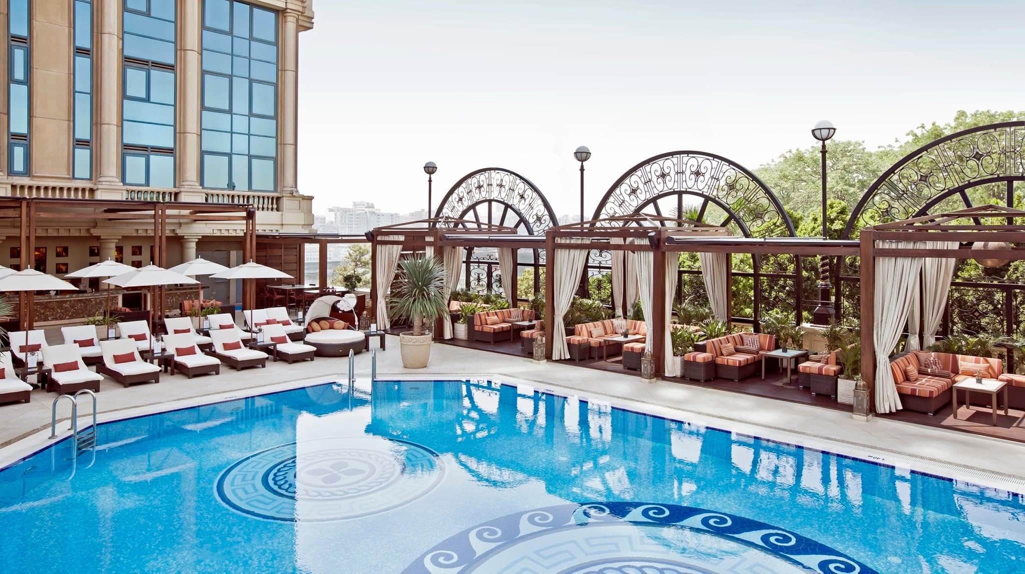 View of the open-air pool deck at Four Seasons First Residence with the Cairo skyline in the background.