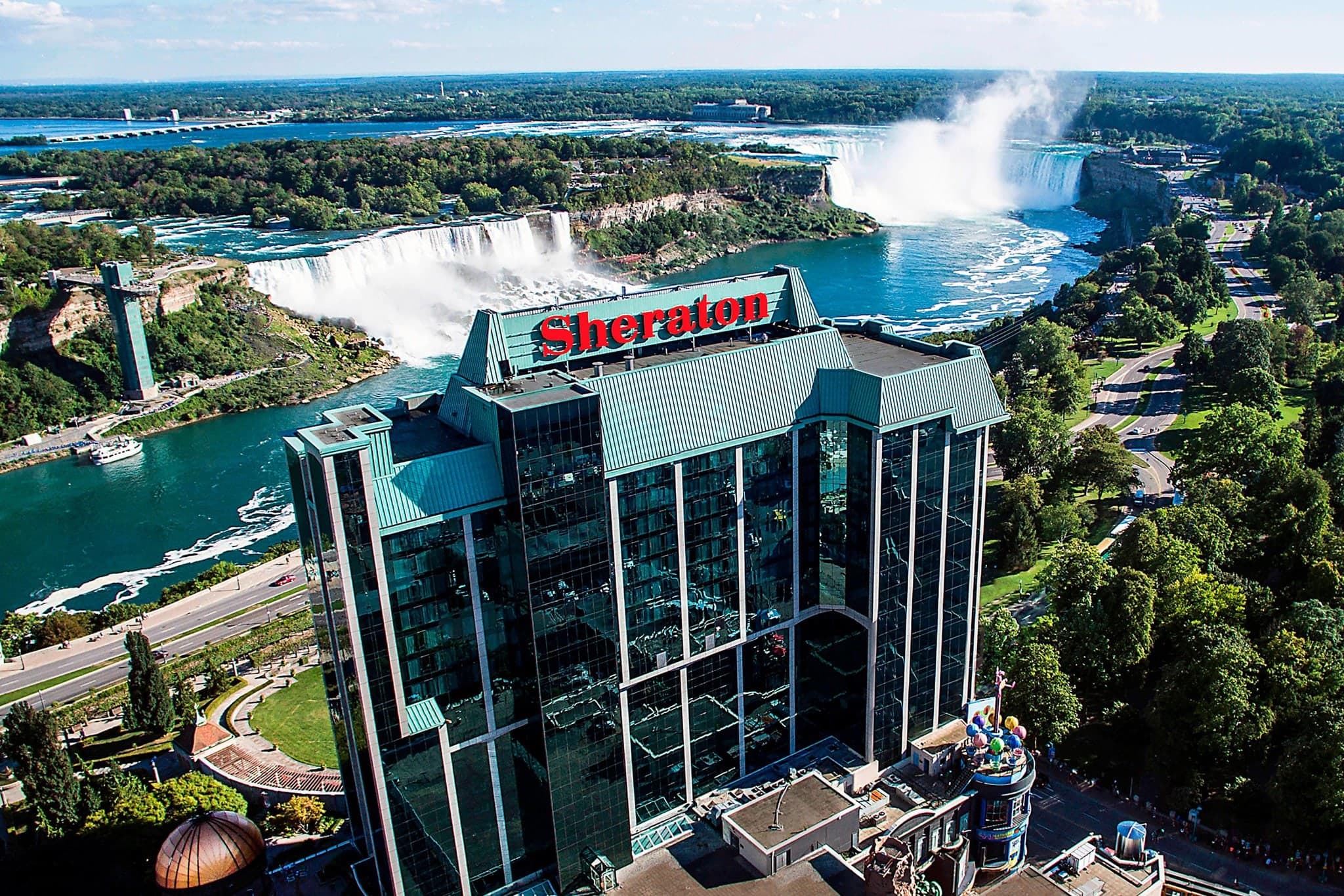 A woman relaxing in the Christienne Fallsview Spa infinity hydrotherapy tub overlooking the mist of the Horseshoe Falls.