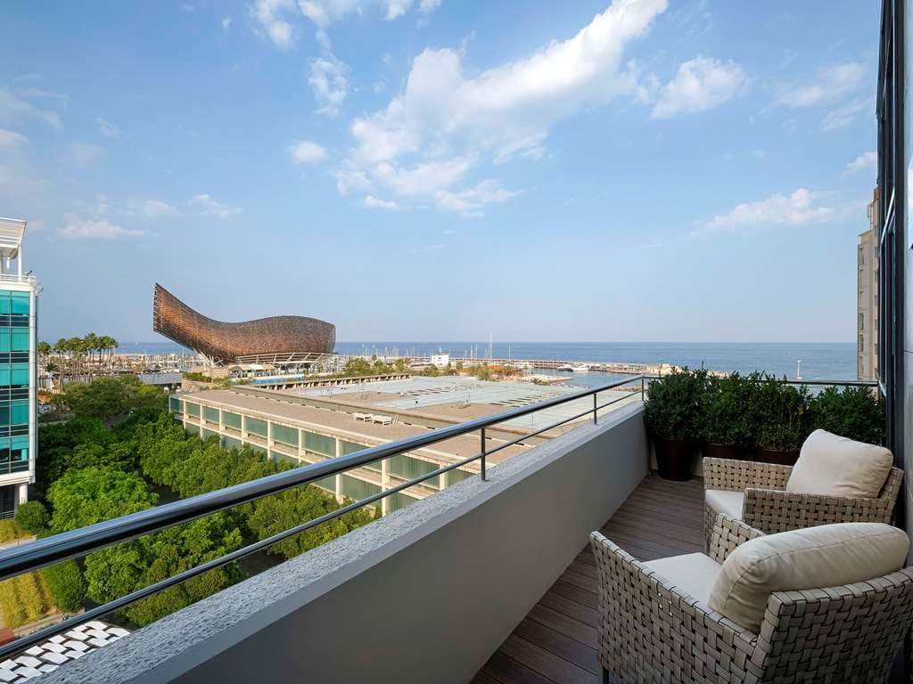 The Sofitel Barcelona Skipper's lush vertical garden facade contrasting with its modern geometric architecture near the Barceloneta beachfront.