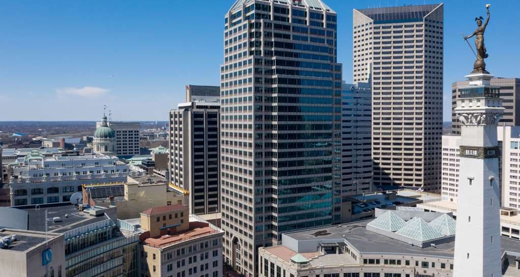 A spacious suite interior at Hilton Indianapolis featuring a separate living area with city views.