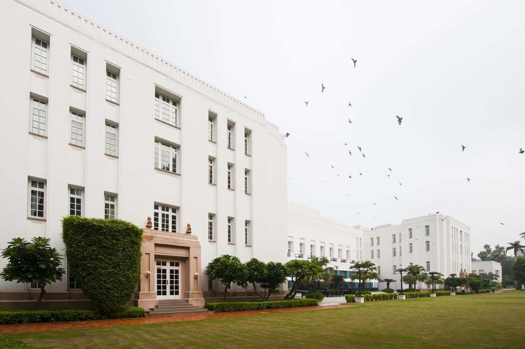 The Imperial New Delhi's iconic Palm Avenue entrance driveway lined with royal palms and colonial white facade.