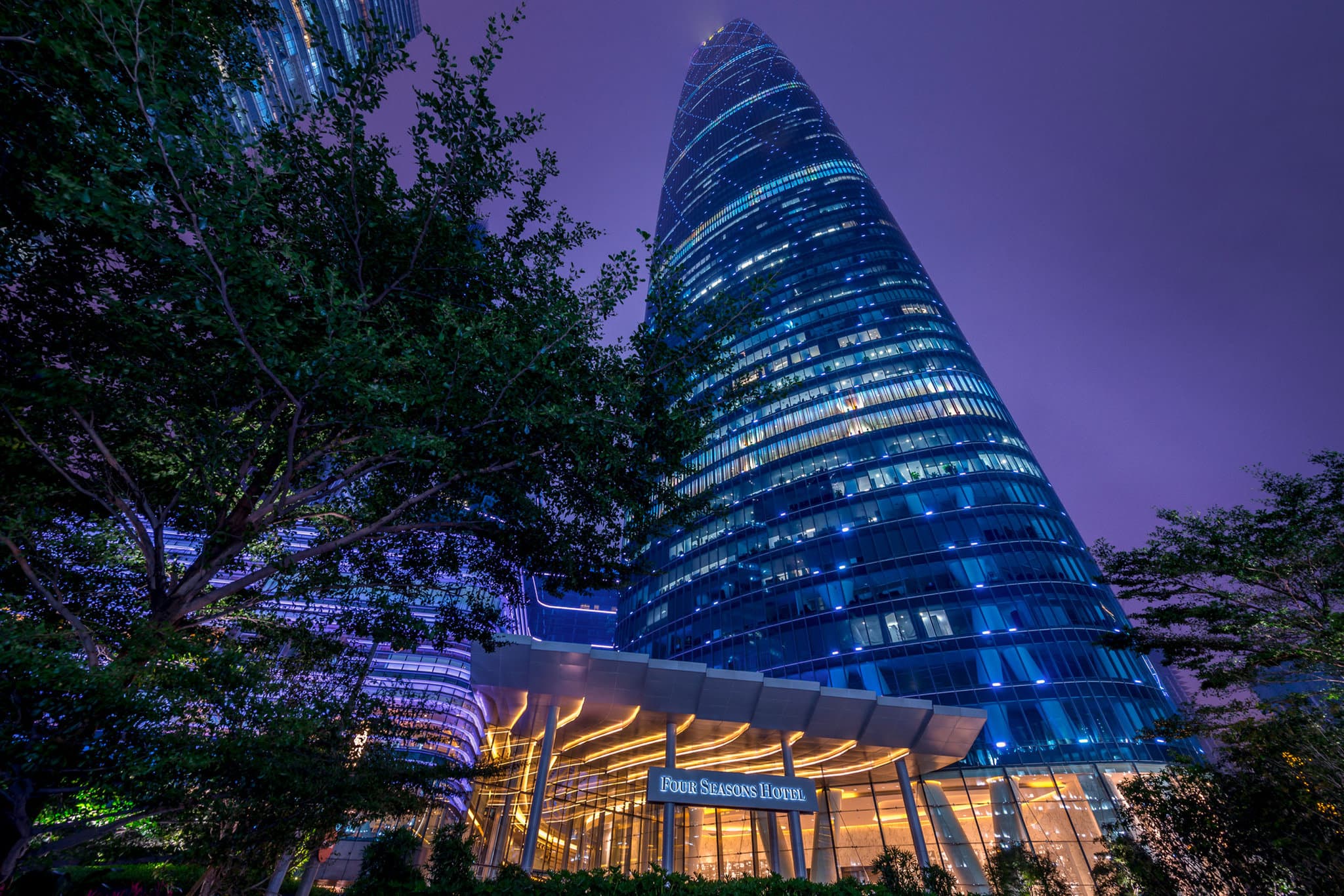 Four Seasons Hotel Guangzhou tall exterior and luxurious room interior with city views