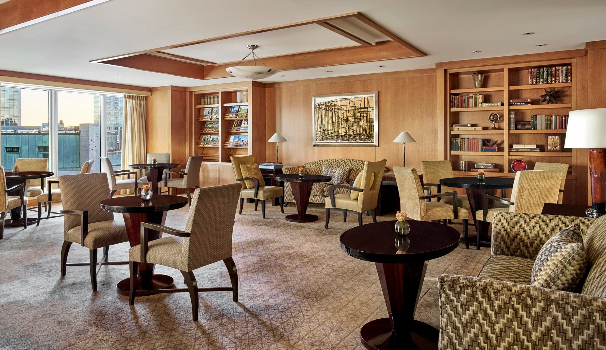 The Avery Bar at The Ritz-Carlton Boston featuring a 13-seat arched bar and elegant chandelier.
