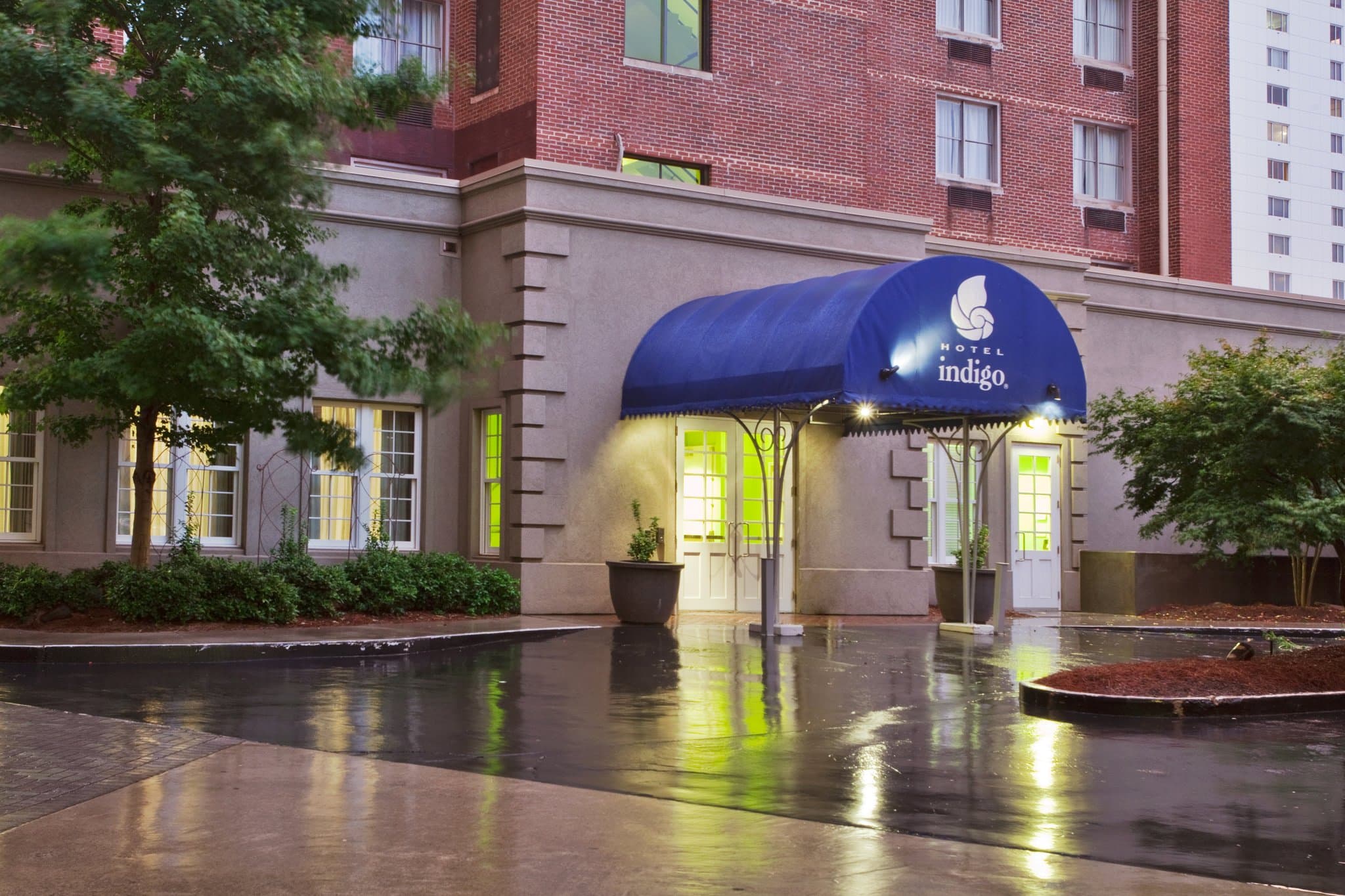 Lobby of Hotel Indigo Atlanta featuring a retro split-flap display board and vibrant murals.