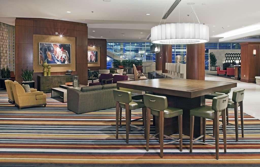 Jun Kaneko ceramic sculptures standing guard at the entrance of the Hilton Omaha, illuminated by warm lobby lights.
