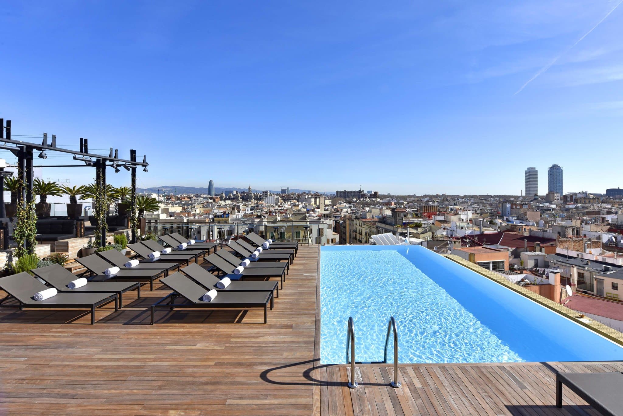 Grand Hotel Central Barcelona infinity pool creating an optical illusion with the adjacent Barcelona Cathedral roof.