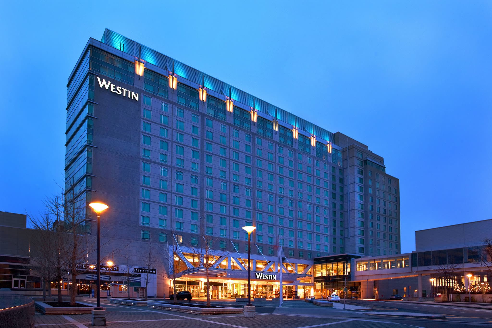 The Westin Boston Seaport District's towering glass facade reflecting the harbor skyline.