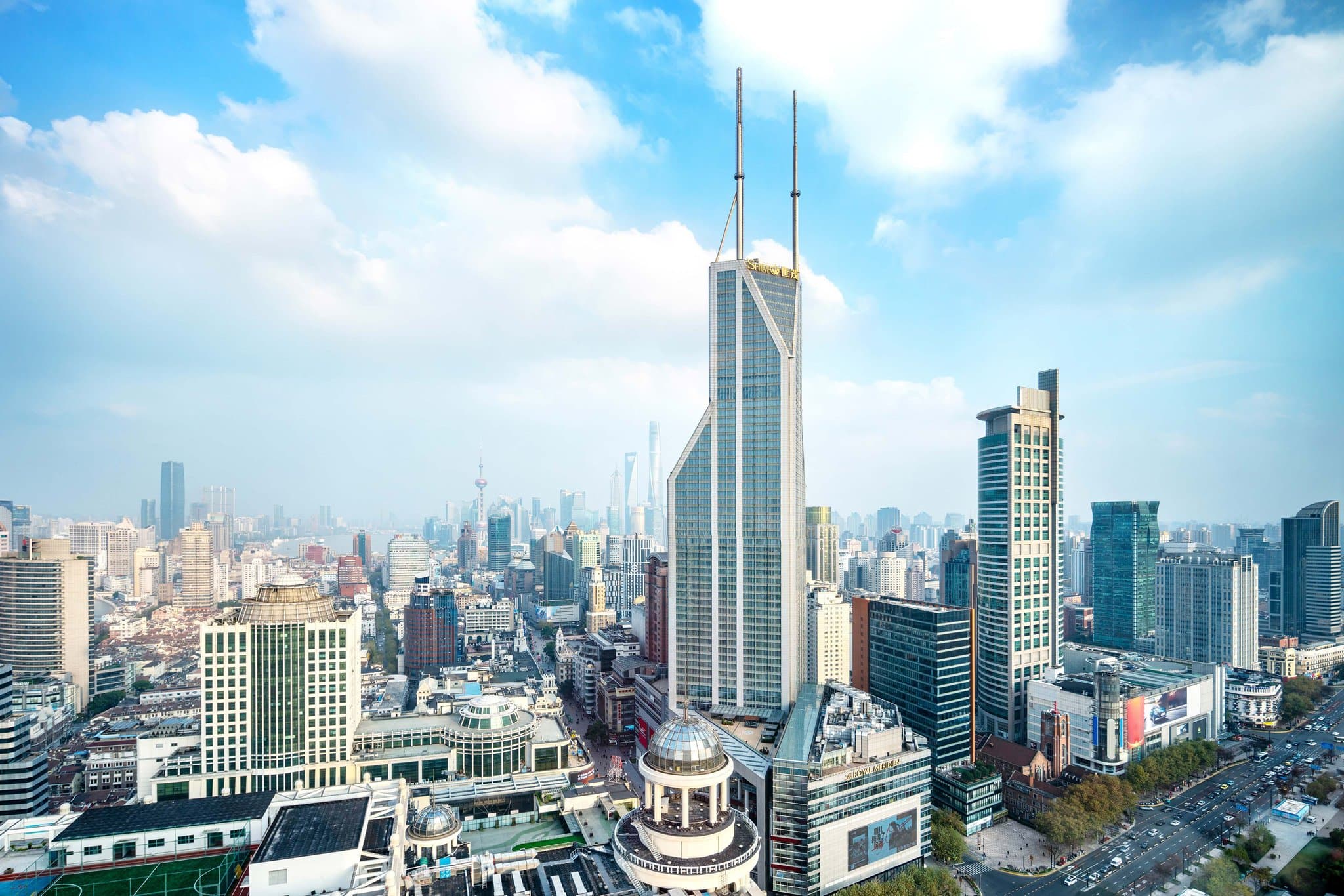 View from Conrad Shanghai Executive Lounge featuring the Oriental Pearl Tower and Pudong skyline through floor-to-ceiling windows.