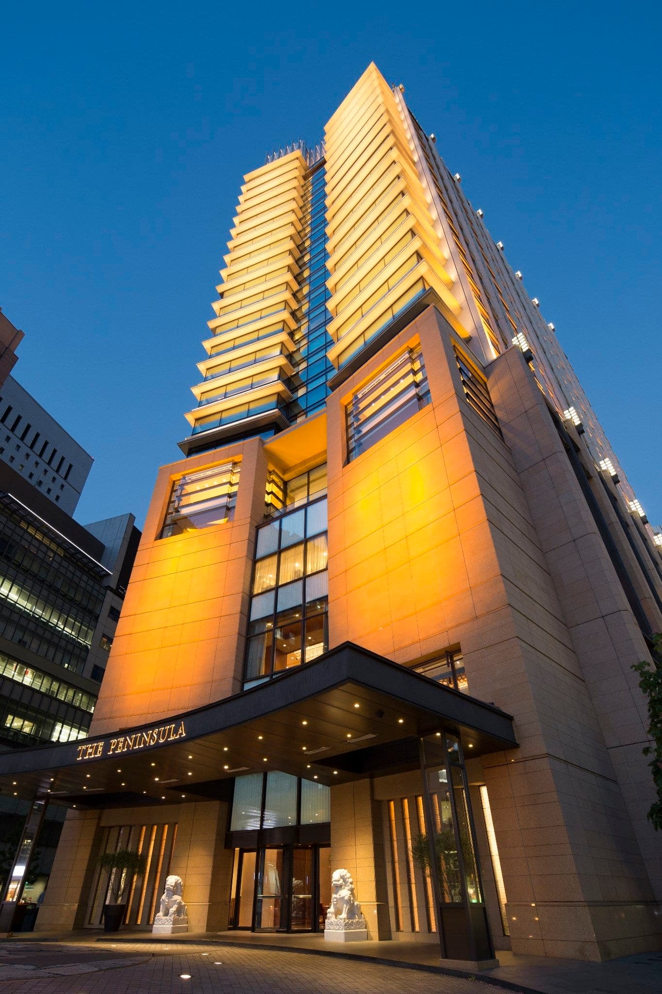 The Peninsula Tokyo lobby featuring the 'Lying Dragon Gate' bamboo sculpture and firework chandelier.