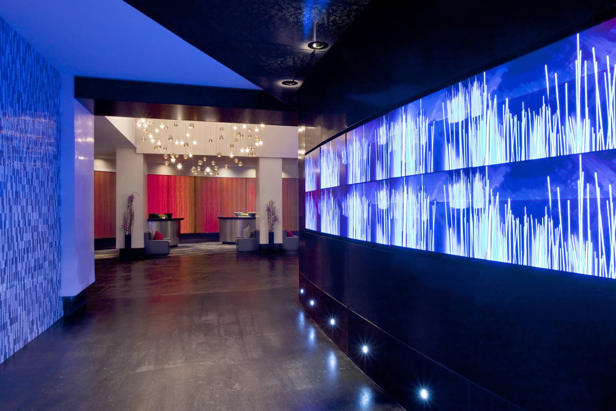 The Starling Atlanta Midtown lobby featuring floating gold birdcages and floral ceiling murals.