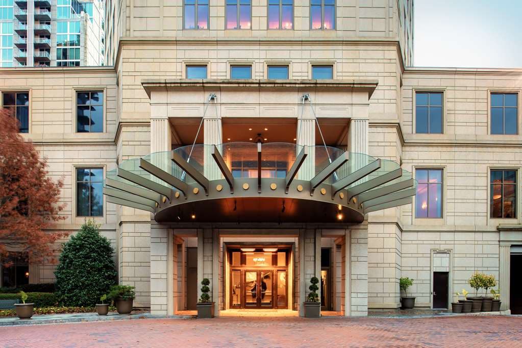 Waldorf Astoria Atlanta Buckhead private English garden with manicured boxwoods and limestone facade.