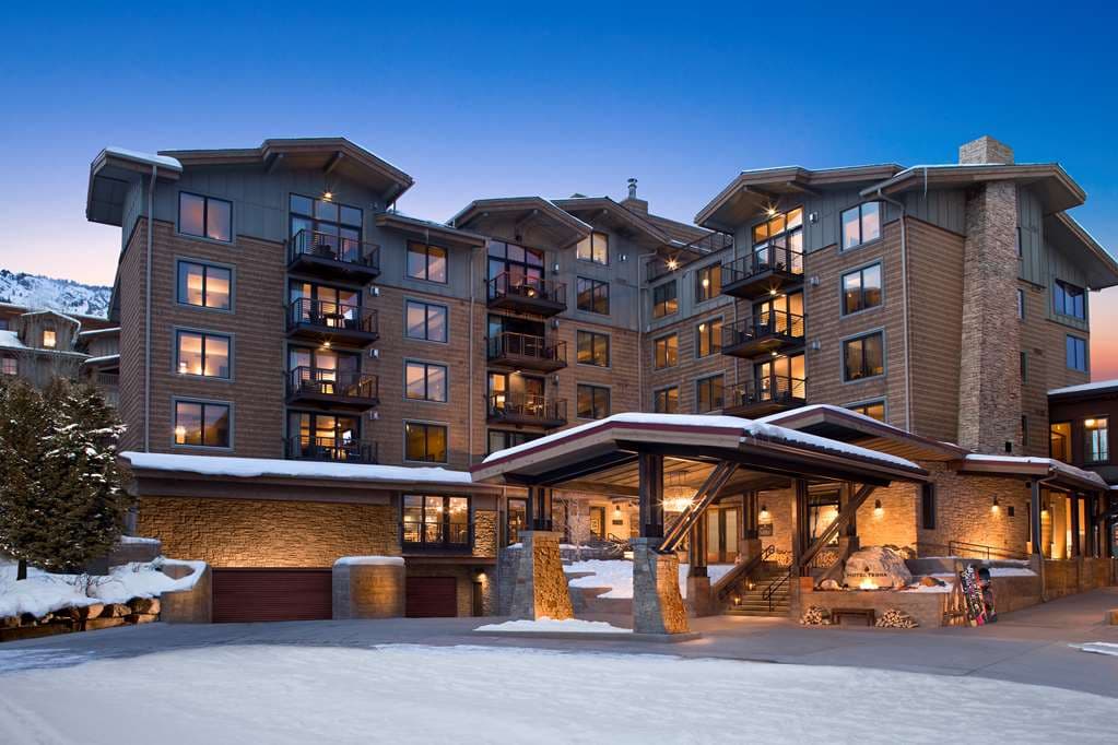 Rooftop saltwater infinity pool at Hotel Terra Jackson Hole with steam rising against a snowy mountain backdrop.