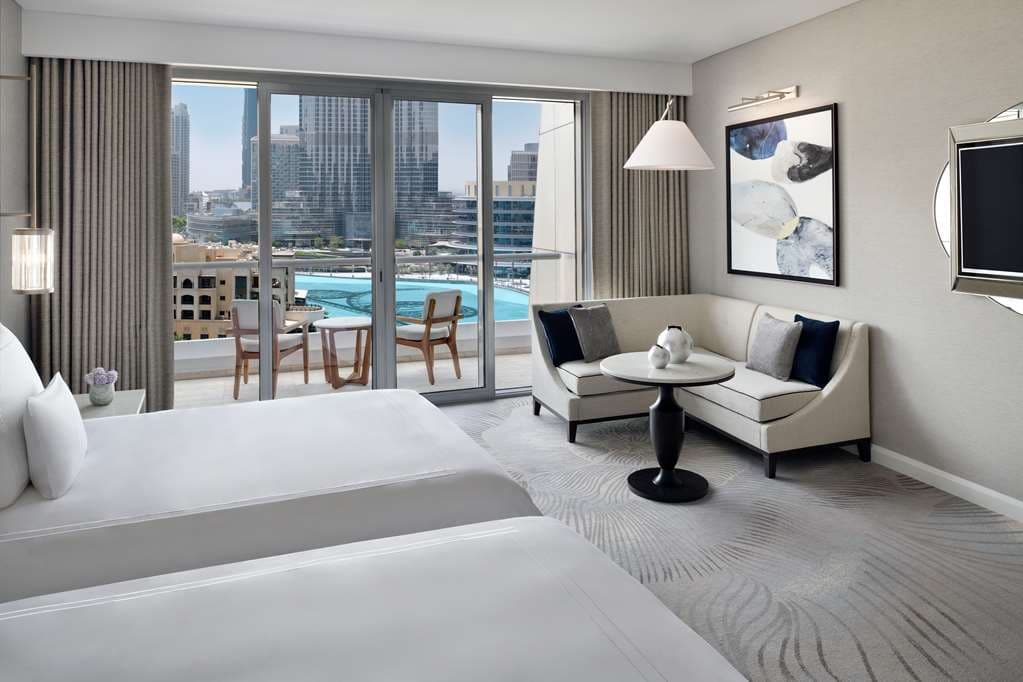 View from Address Downtown balcony overlooking the Dubai Fountains and the Burj Khalifa at twilight.