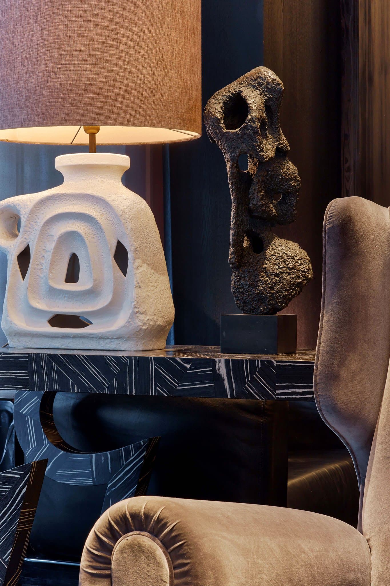 The iconic oval window of the Eiffel View Suite at Le Metropolitan, framing the Eiffel Tower perfectly against a blue Parisian sky.