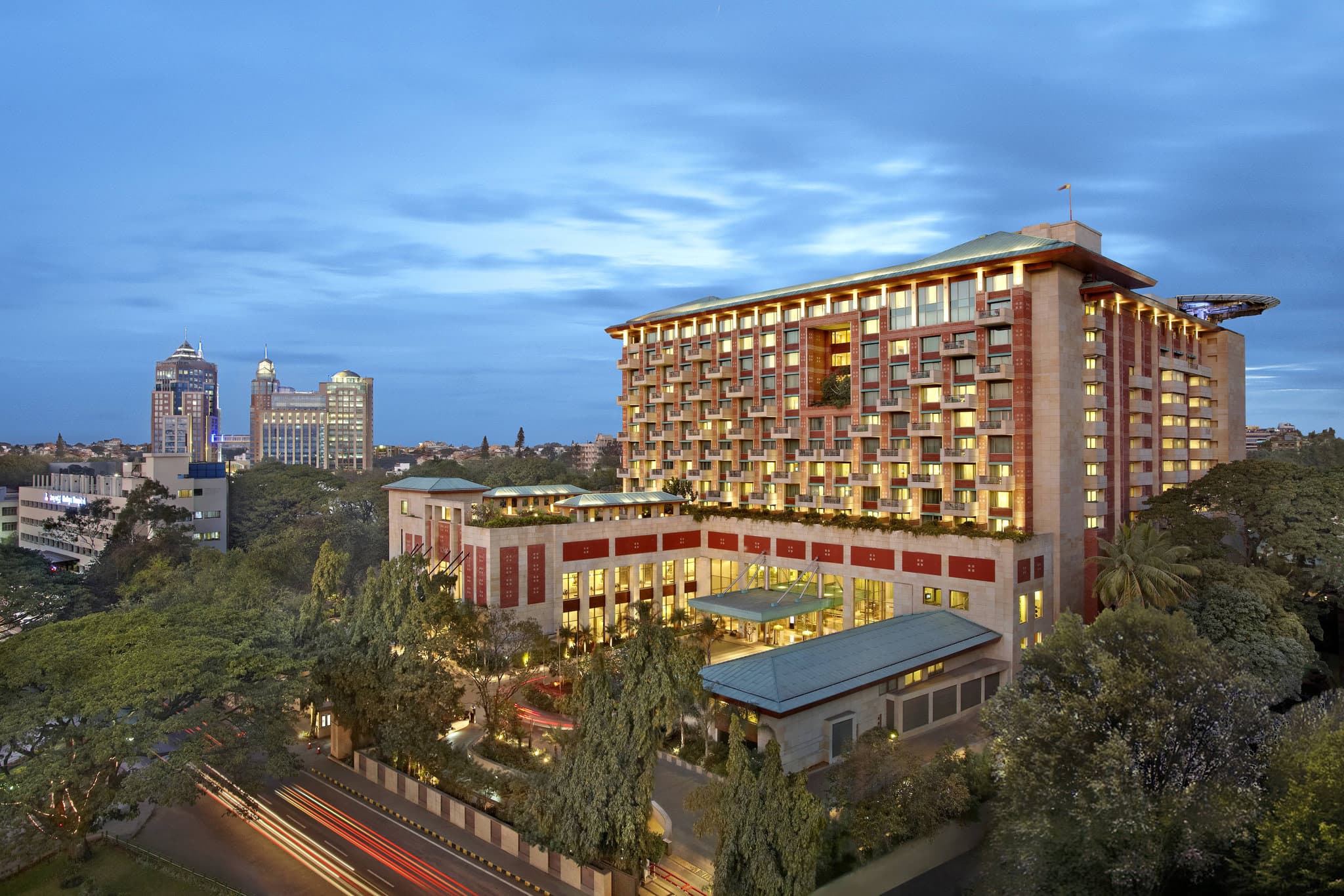 The open-air Lotus Pavilion at ITC Gardenia with its signature grass roof and vertical garden backdrop.