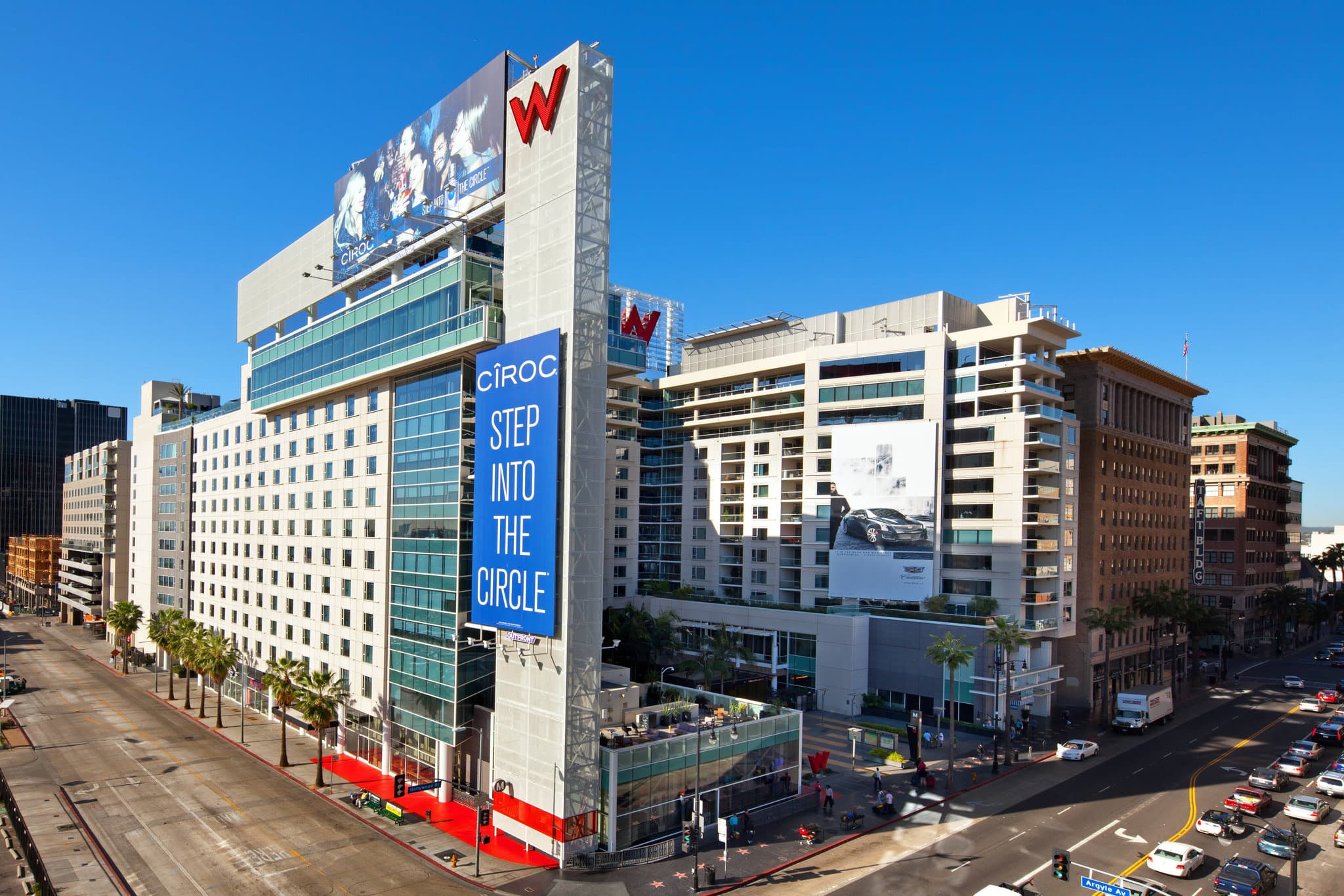 Rooftop WET Deck pool at W Hollywood with guests lounging and the Hollywood Sign visible in the background.