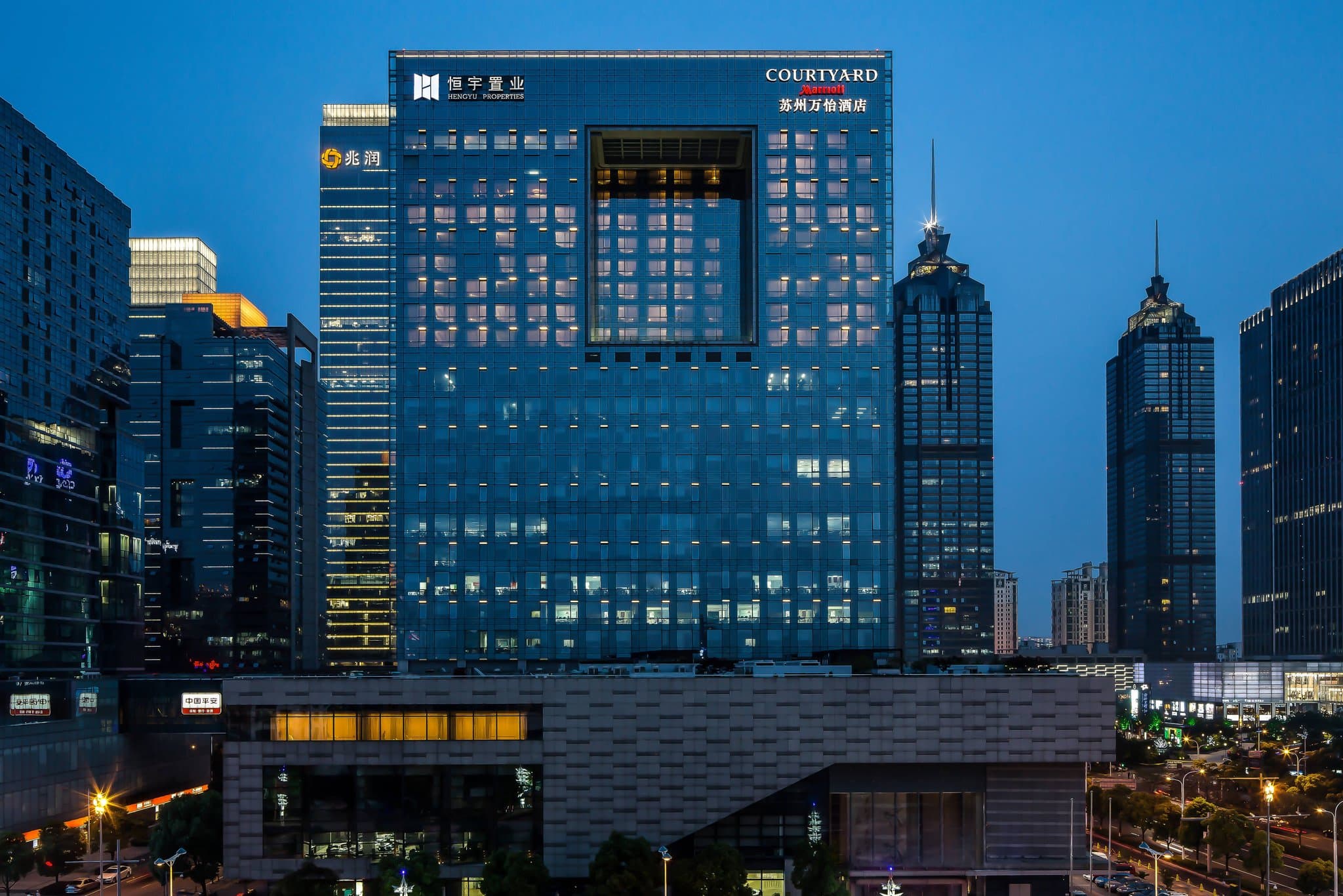 Exterior and modern lobby of Courtyard by Marriott Suzhou near Jinji Lake.