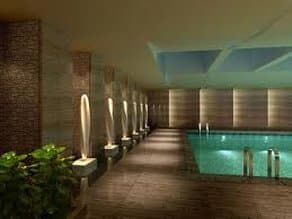 Grand marble lobby of Holiday Inn Nantong Oasis International with warm lighting and reflective floors.