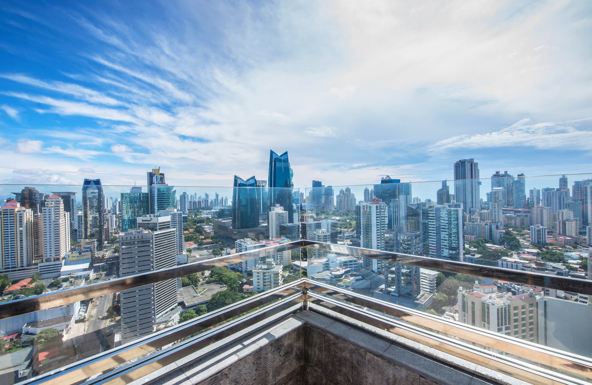 A dramatic dusk view of the Eurostars Panama City rooftop pool on the 27th floor, with the illuminated Panama City skyline and high-rises in the background.