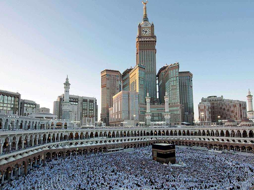 A sweeping view of the Holy Kaaba seen through the floor-to-ceiling arched window of a Pullman Zamzam suite.