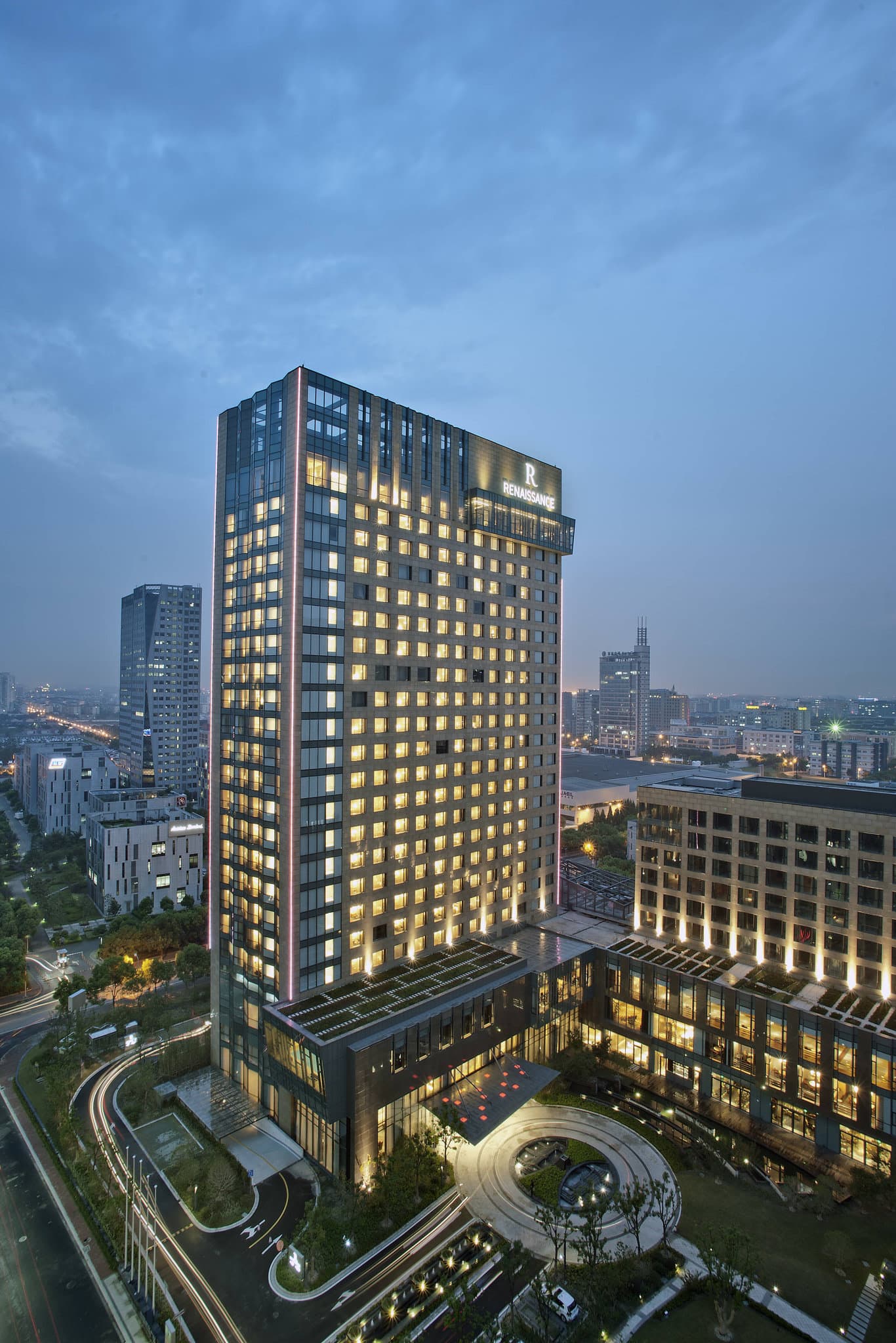 Spacious and clean room at Renaissance Caohejing Shanghai with modern amenities and large windows.