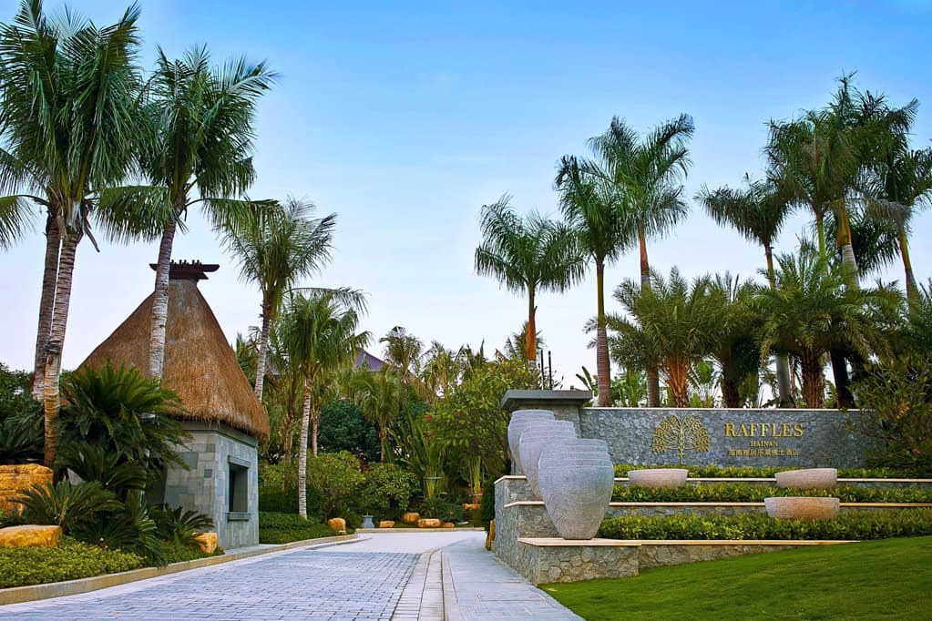 Aerial view of Raffles Hainan private pool villas surrounded by lush tropical gardens and the South China Sea.