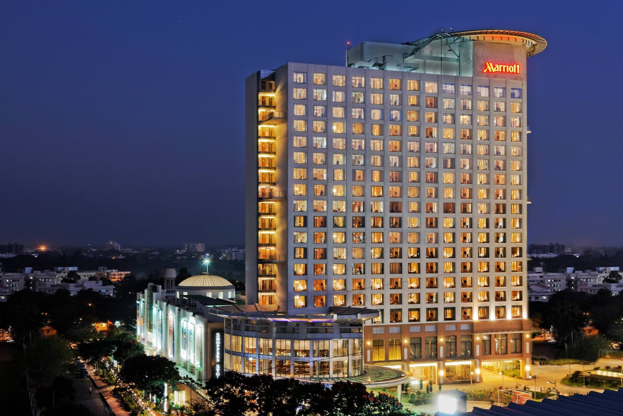 Bengaluru Marriott Whitefield lobby featuring a massive crystal chandelier and modern seating.