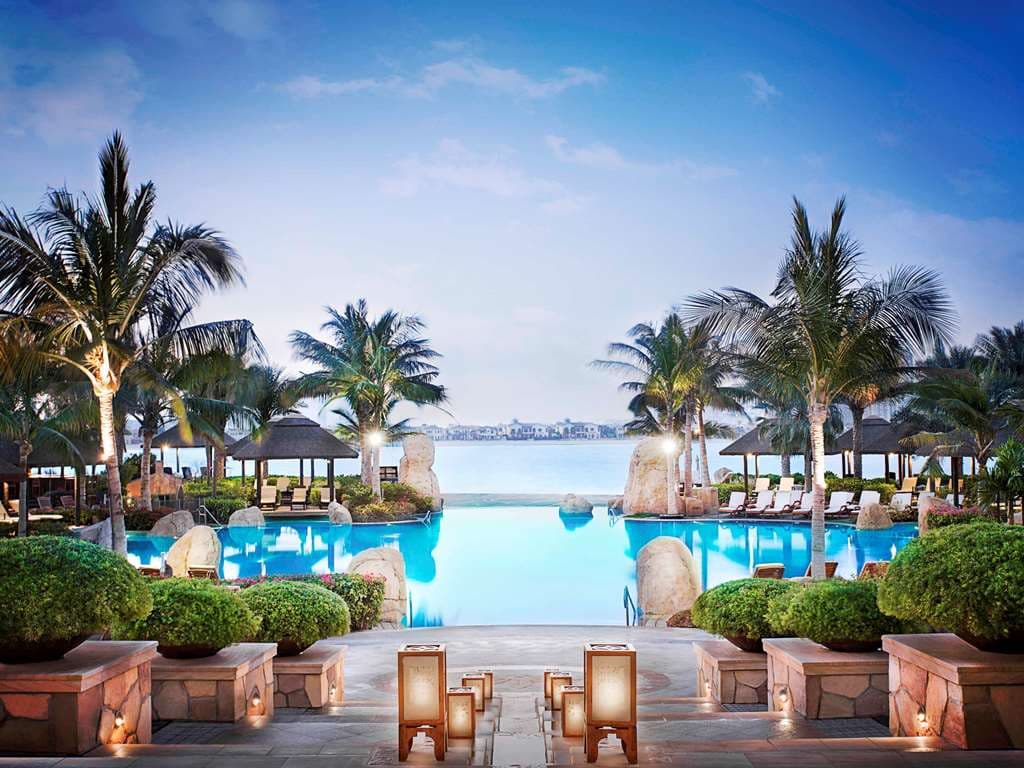 A lush, vertical garden wall in the lobby of Sofitel Dubai The Palm with Polynesian wood accents.