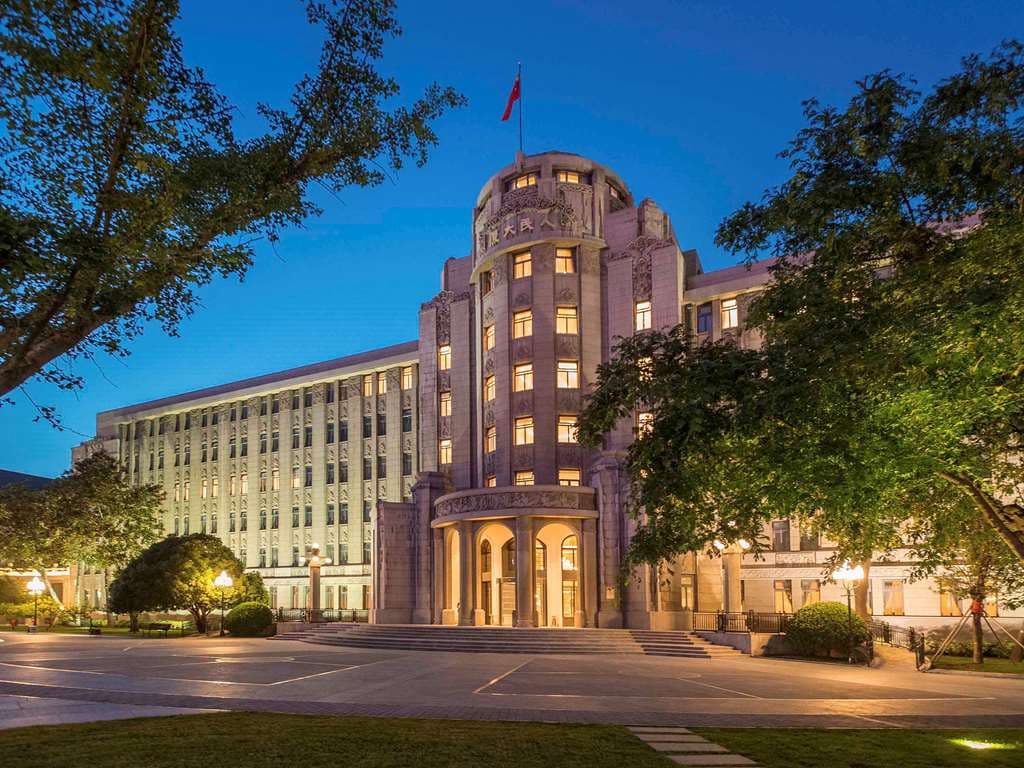 Exterior view of the historic Sofitel Legend People's Xian featuring lush landscaped gardens.
