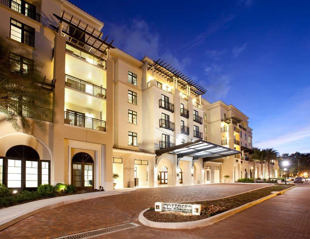 The Alfond Inn's glass-domed conservatory filled with natural light and contemporary art sculptures.