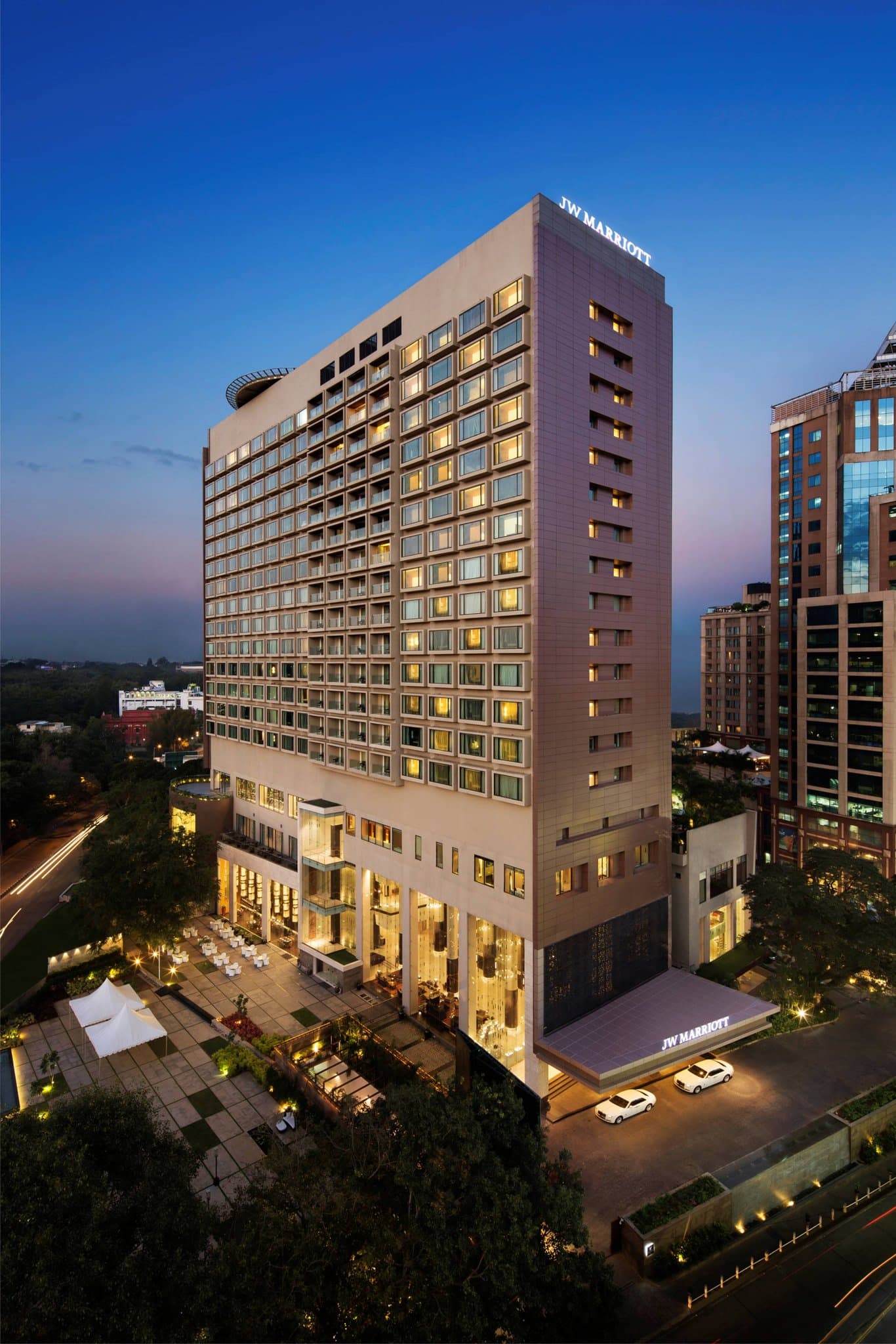 View from a private balcony at JW Marriott Bengaluru overlooking the lush green canopy of Cubbon Park and the city skyline.