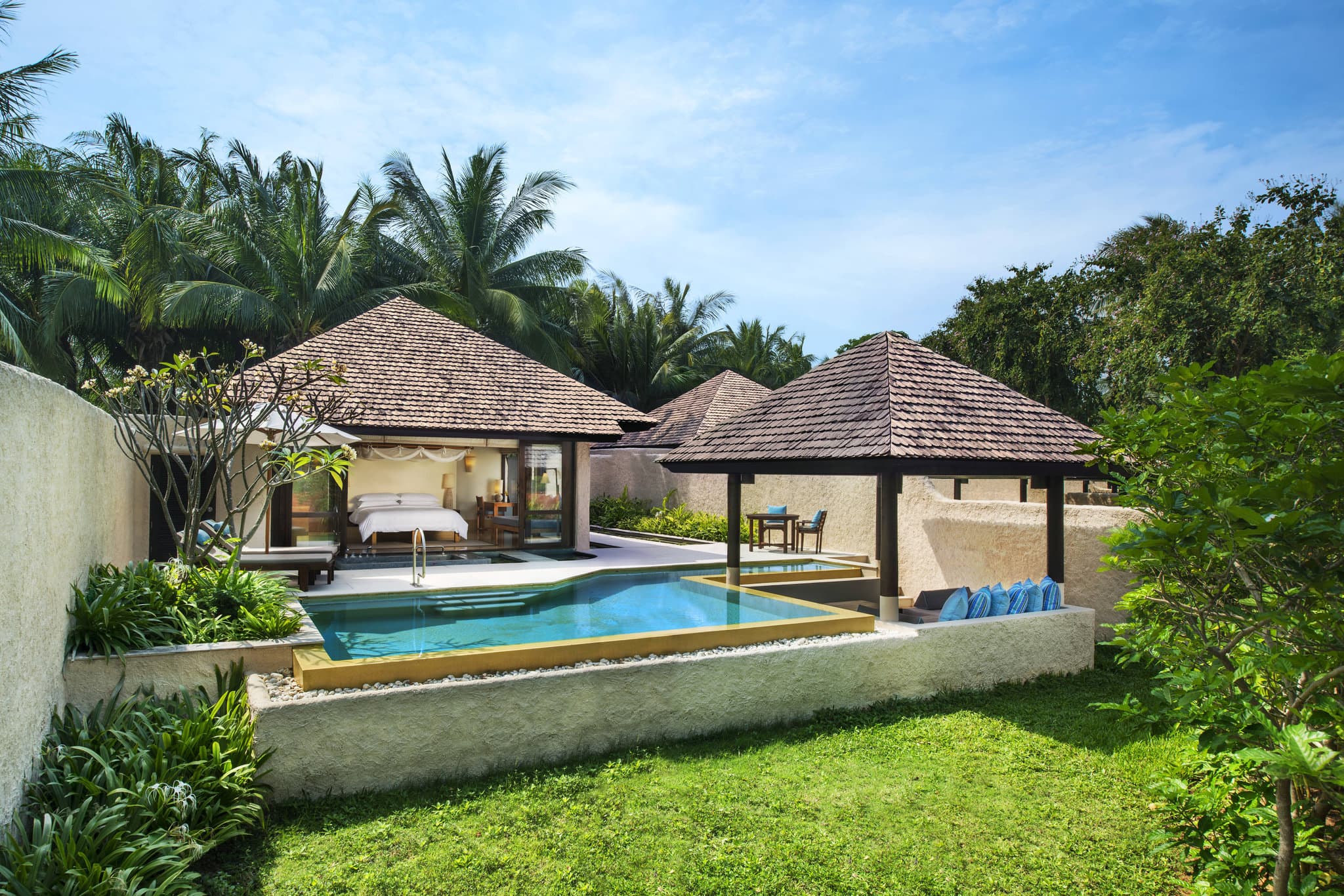 A private sunken pool inside a Sheraton Hua Hin Pranburi villa, surrounded by lush tropical walls and a wooden deck.
