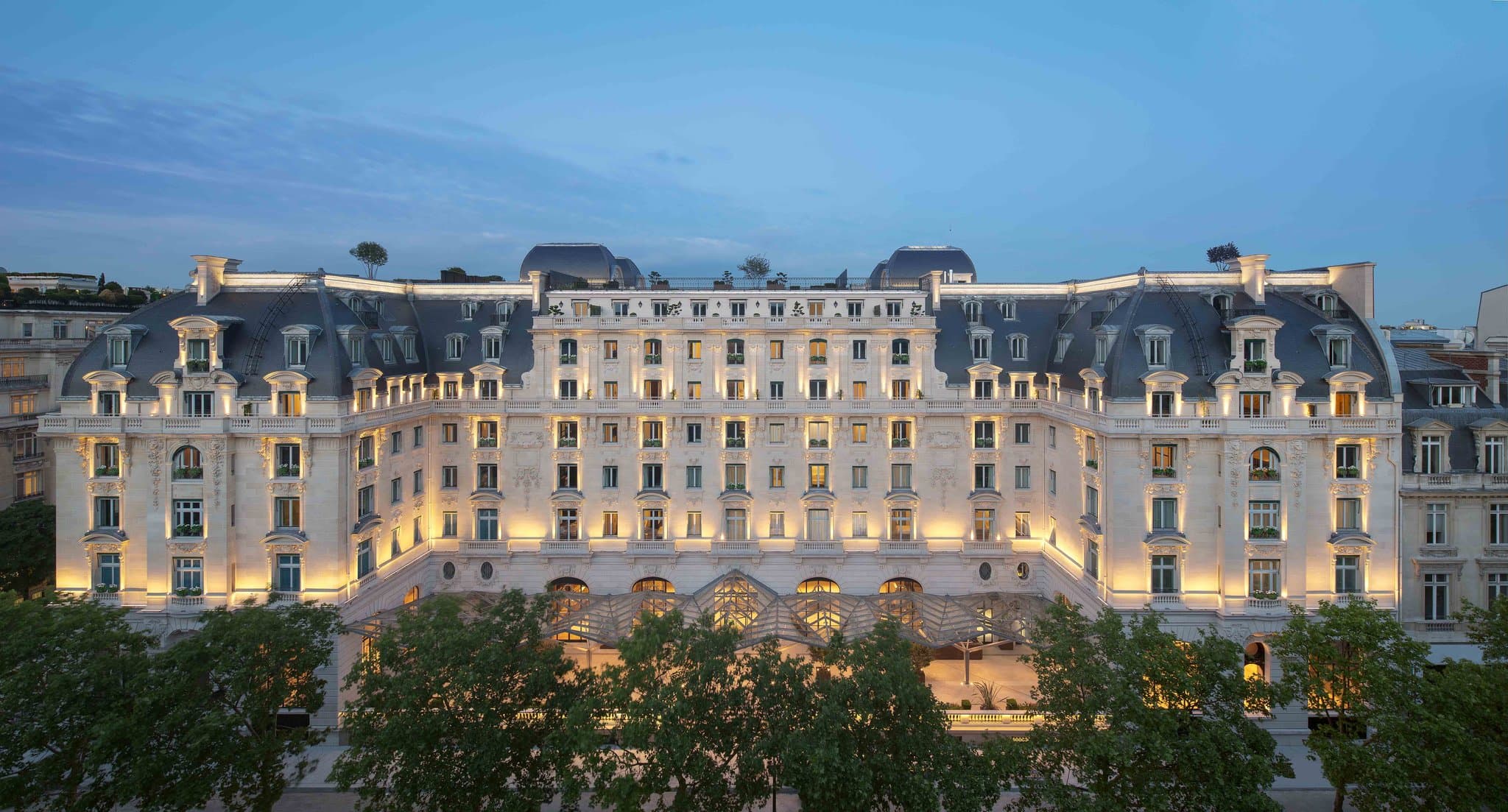 The rooftop restaurant L'Oiseau Blanc at The Peninsula Paris featuring a biplane replica and views of the Eiffel Tower.