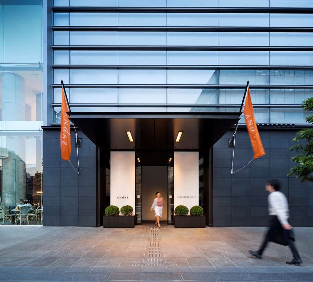 A low-angle shot of the Andaz Tokyo Rooftop Chapel with its copper roof glowing under evening lights, set against the dark silhouette of the Tokyo skyline.