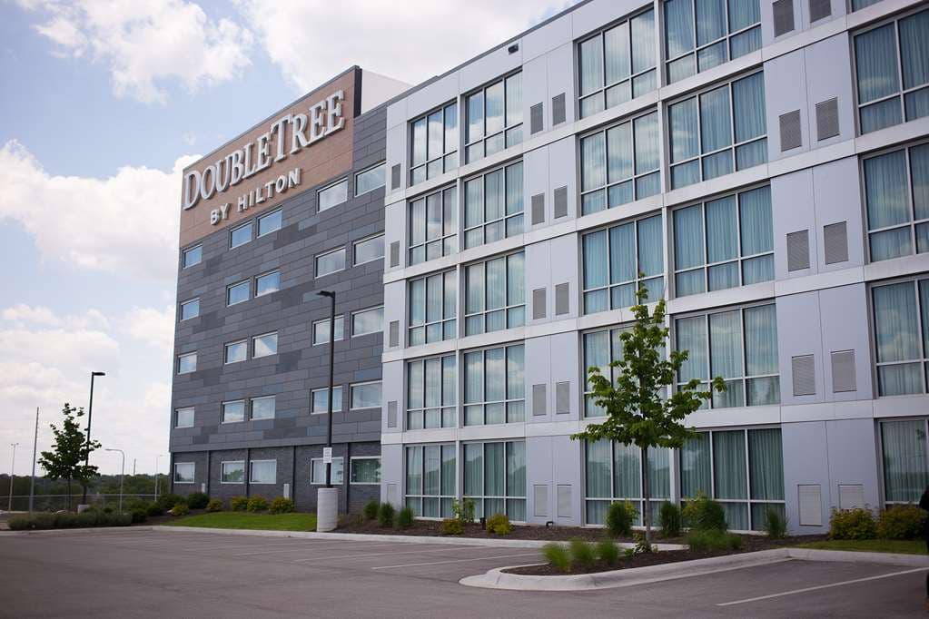 Glass-enclosed atrium pool area at DoubleTree Omaha Southwest with natural light flooding the deck.