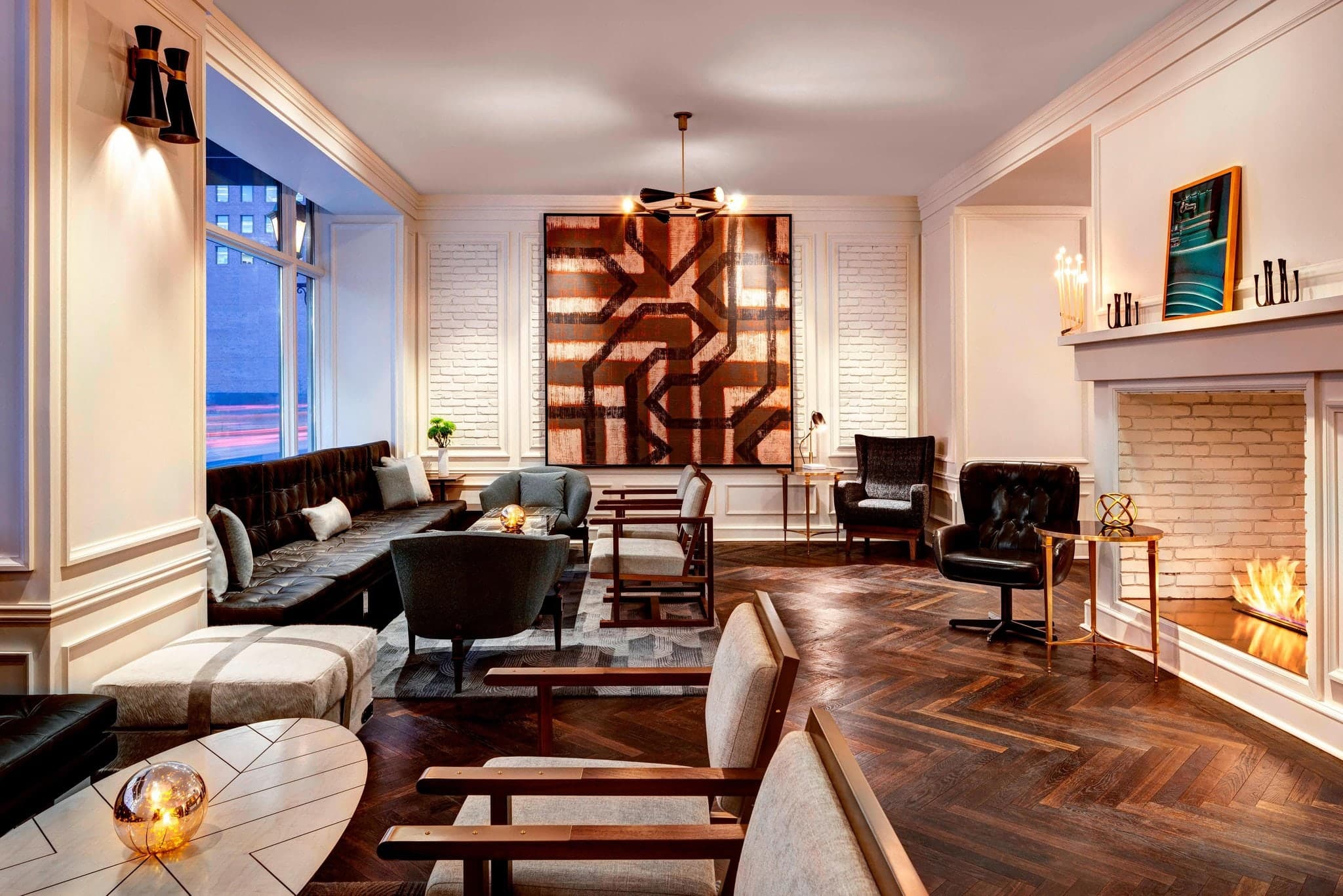 Le Méridien Indianapolis lobby featuring modern art installations and mid-century furniture inside a historic 1928 building.