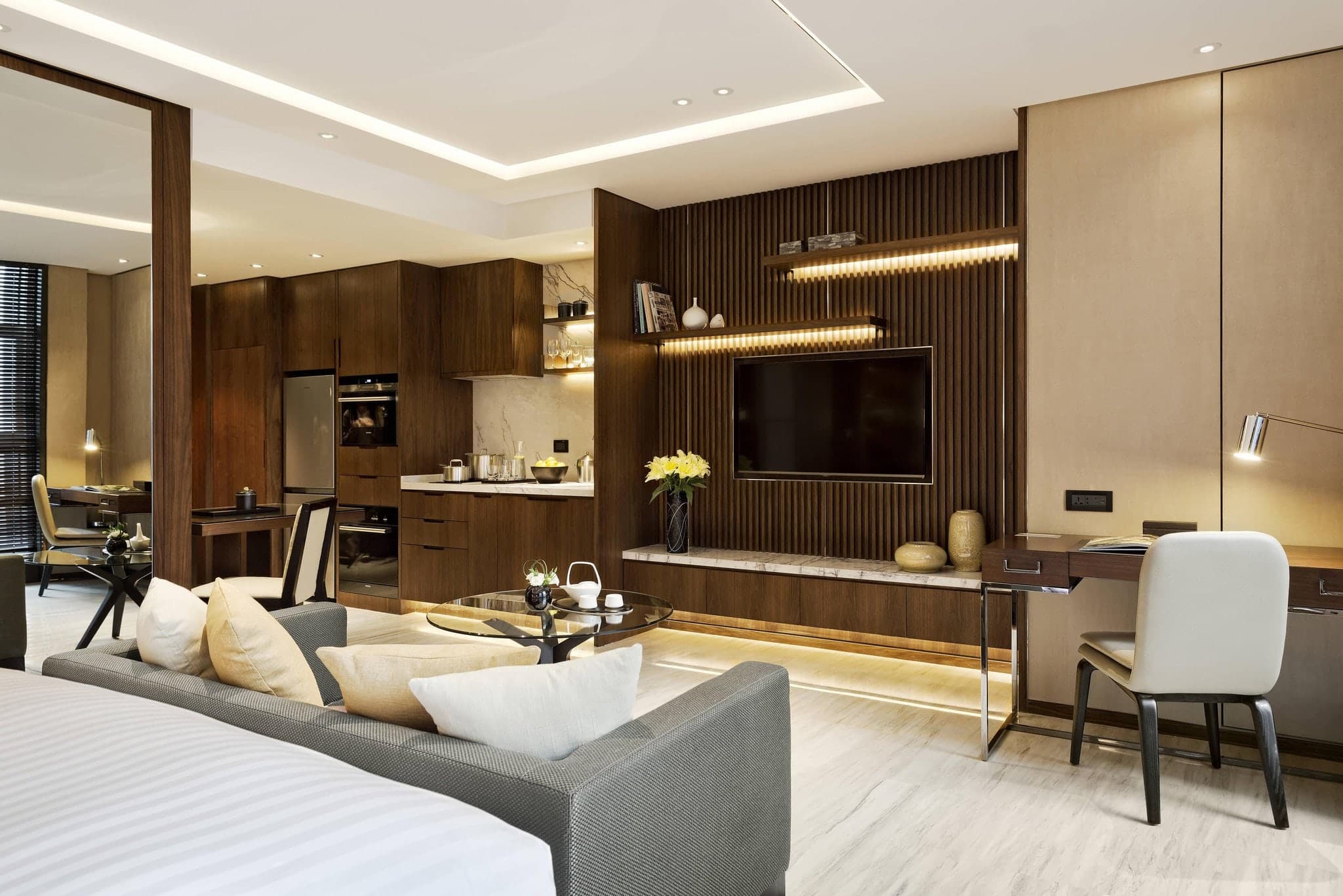 A sun-drenched, modern studio apartment living room in Xi'an with floor-to-ceiling windows and minimalist decor.
