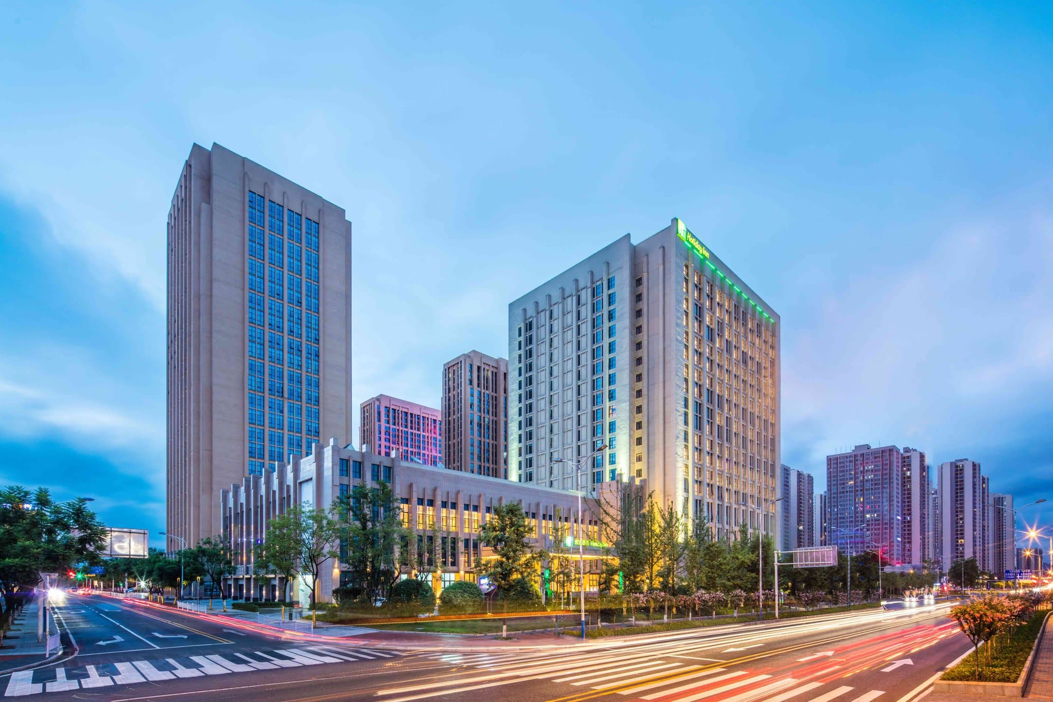 A geometrically designed indoor heated pool at Holiday Inn Chongqing University Town with warm ambient lighting.