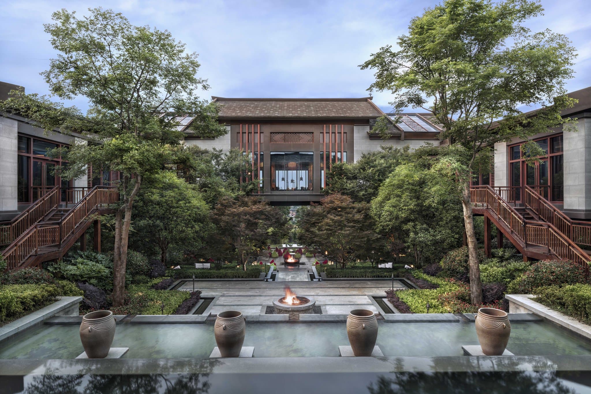 A private pool villa at Anantara Guiyang Resort with a floating breakfast tray, set against a dramatic backdrop of limestone karst mountains.