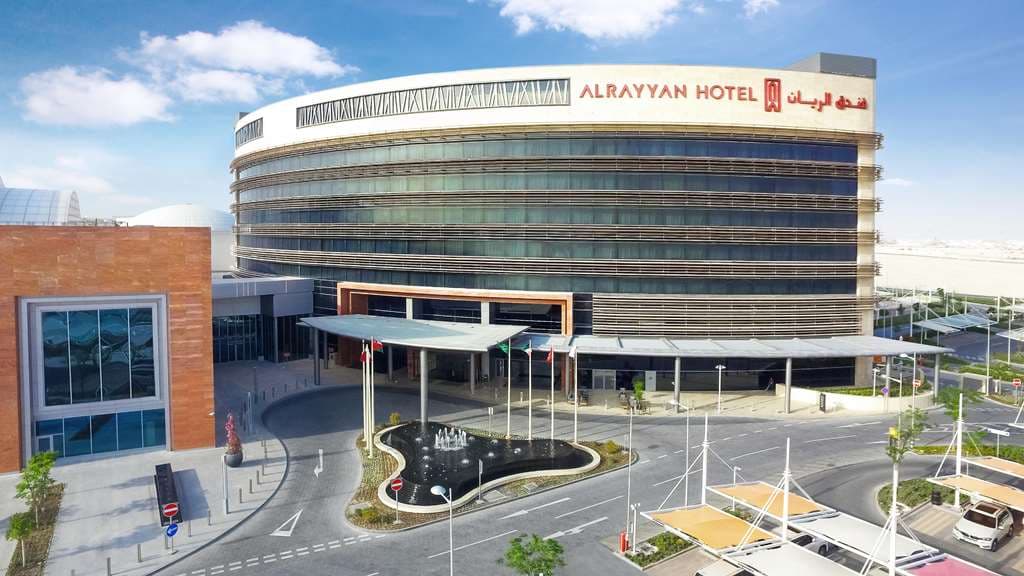 Rooftop saltwater pools at AlRayyan Hotel Doha with stone architecture and lounge seating.